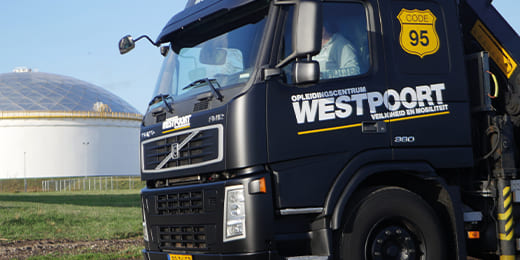 Zwarte Volvo-vrachtwagen met Westpoort-logo en Code 95 schild, ter promotie van rijopleidingen en Code 95 nascholing.